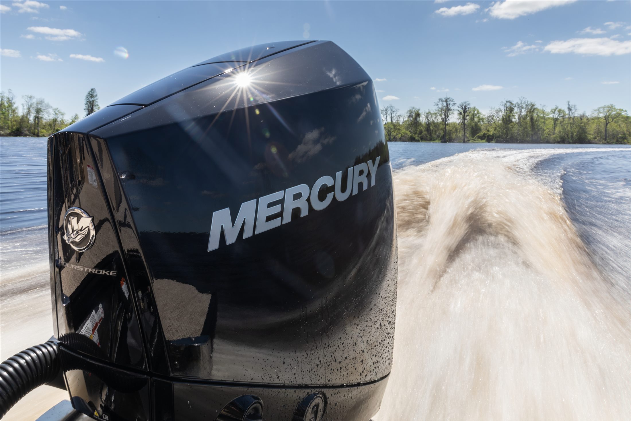 Mercury Verado outboard running across the lake